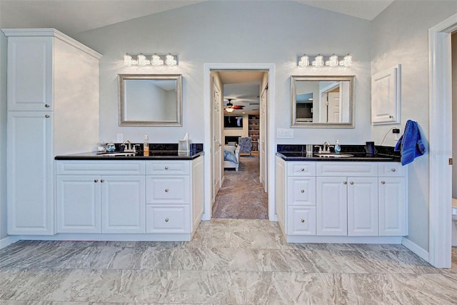 bathroom featuring ceiling fan, vanity, vaulted ceiling, and toilet