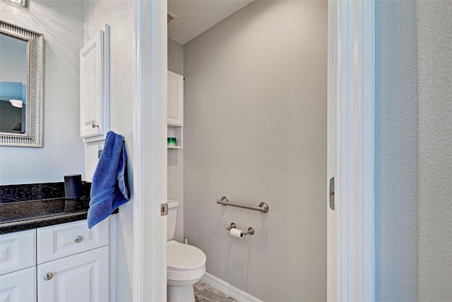 bathroom with vanity, toilet, and tile patterned floors