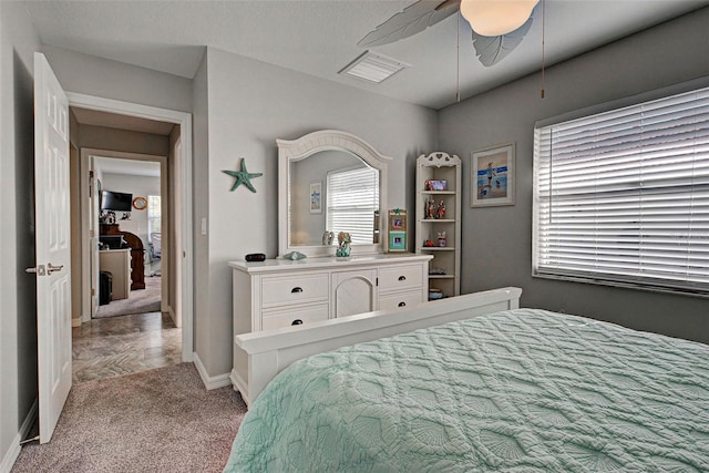 bedroom featuring light carpet and ceiling fan