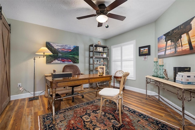 office space with a textured ceiling, ceiling fan, and hardwood / wood-style flooring