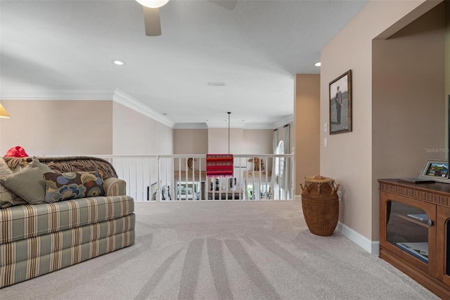 carpeted living room with ornamental molding and ceiling fan