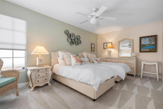 bedroom with light carpet and ceiling fan