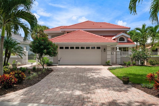 mediterranean / spanish-style home featuring a garage