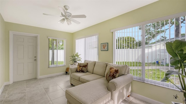 tiled living room featuring ceiling fan