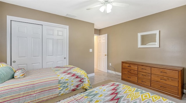 tiled bedroom featuring a closet and ceiling fan