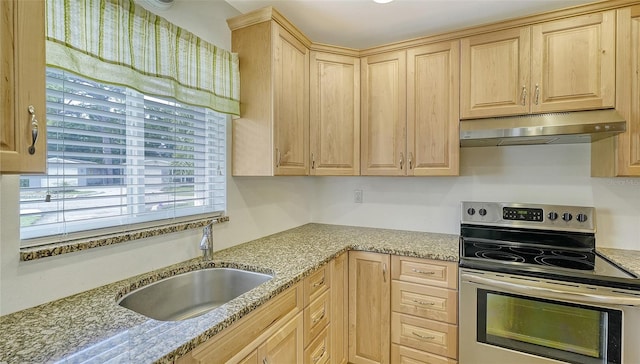 kitchen with stainless steel electric range, light brown cabinets, light stone counters, and sink