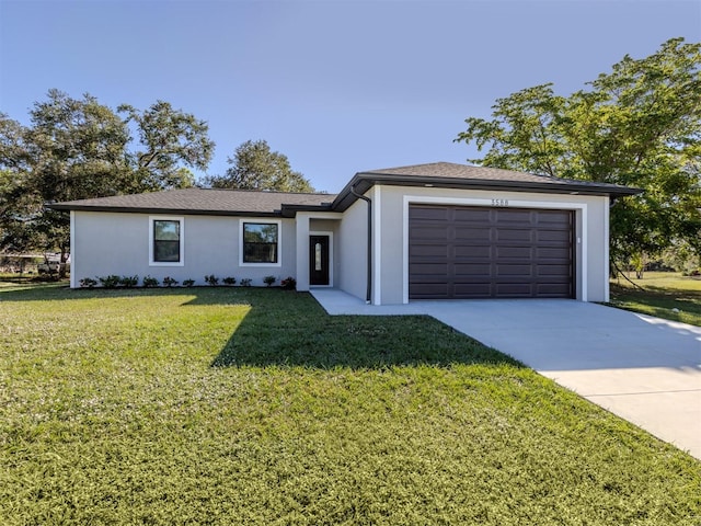 view of front facade featuring a front yard and a garage