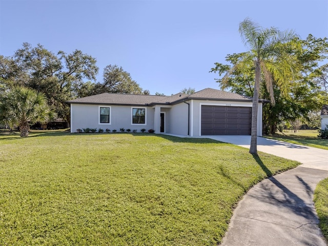 single story home with a front yard and a garage