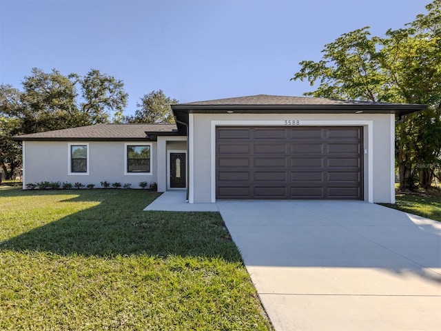 view of front of property featuring a front yard and a garage