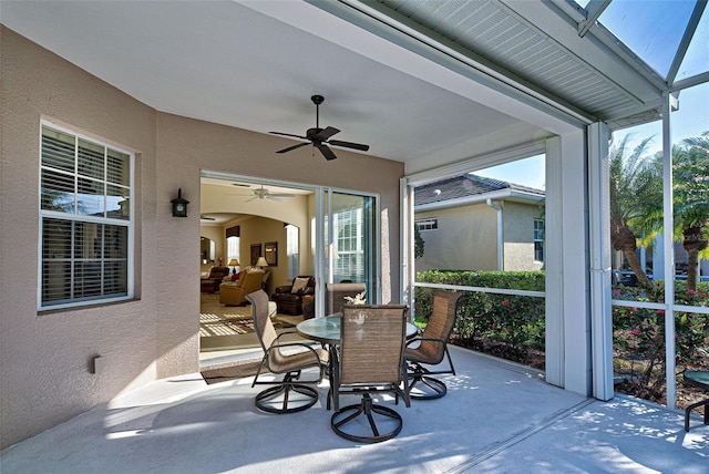 sunroom featuring ceiling fan