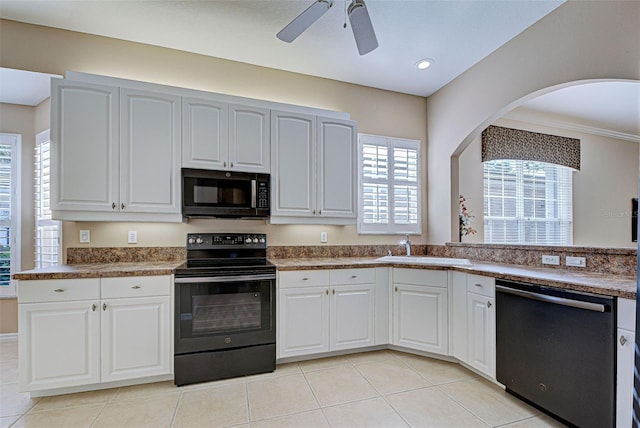 kitchen with black appliances, plenty of natural light, white cabinets, and sink