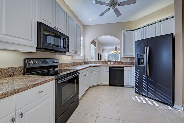 kitchen featuring black appliances, ceiling fan with notable chandelier, light tile patterned flooring, and white cabinetry