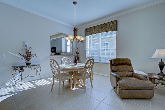 tiled dining room featuring a chandelier and ornamental molding