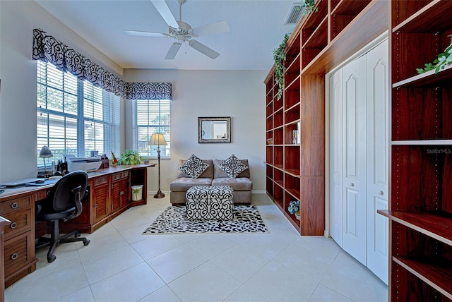 home office with ceiling fan and light tile patterned floors