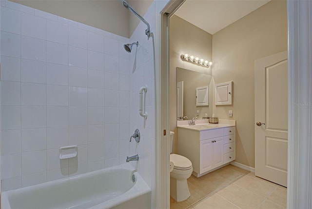 full bathroom featuring toilet, vanity, tile patterned floors, and tiled shower / bath combo