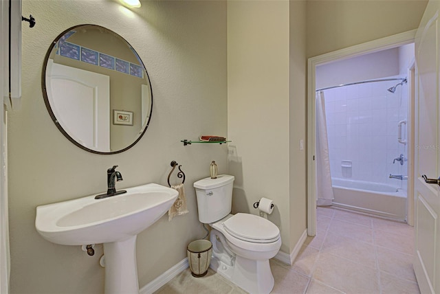 bathroom featuring tile patterned flooring, shower / tub combo, and toilet