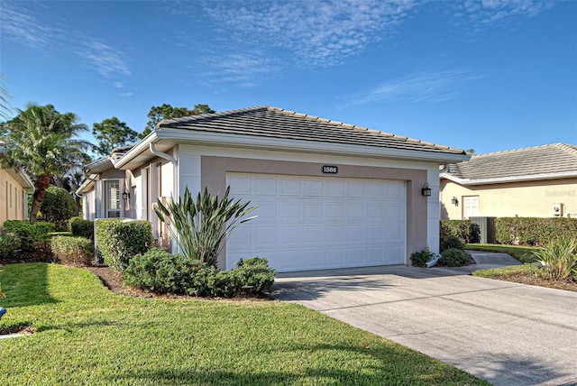 1586 Monarch Dr Unit 1586, Venice, FL 34293 - view of front facade featuring a tile roof, concrete driveway, an attached garage, and stucco siding