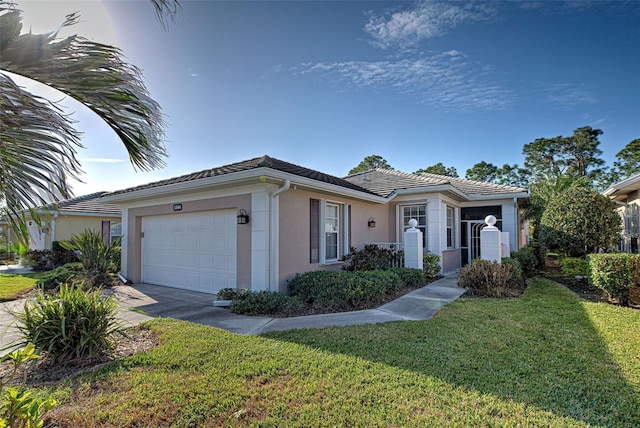 1586 Monarch Dr Unit 1586, Venice, FL 34293 - ranch-style house featuring driveway, a tile roof, a front yard, an attached garage, and stucco siding