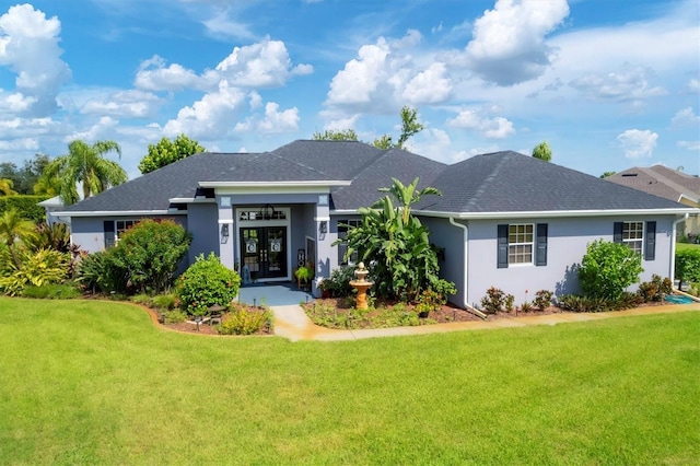 ranch-style house featuring a front yard and french doors