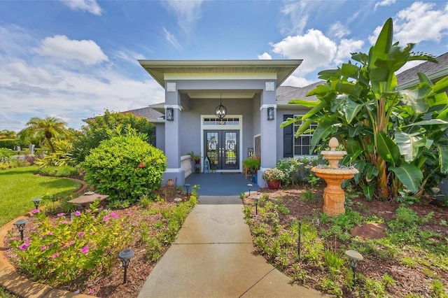 view of exterior entry featuring french doors