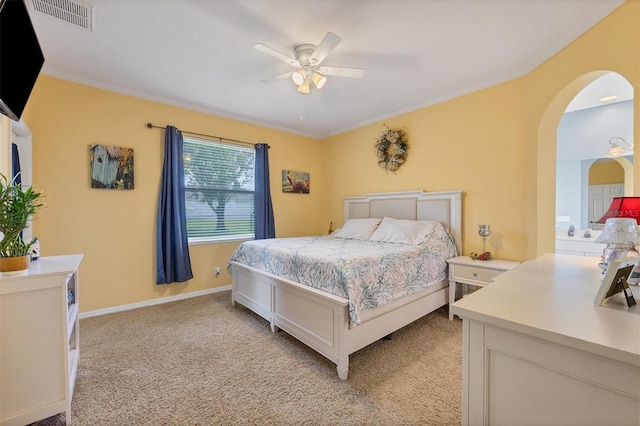 carpeted bedroom featuring ornamental molding and ceiling fan