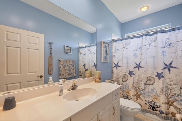 bathroom featuring walk in shower, vanity, and toilet