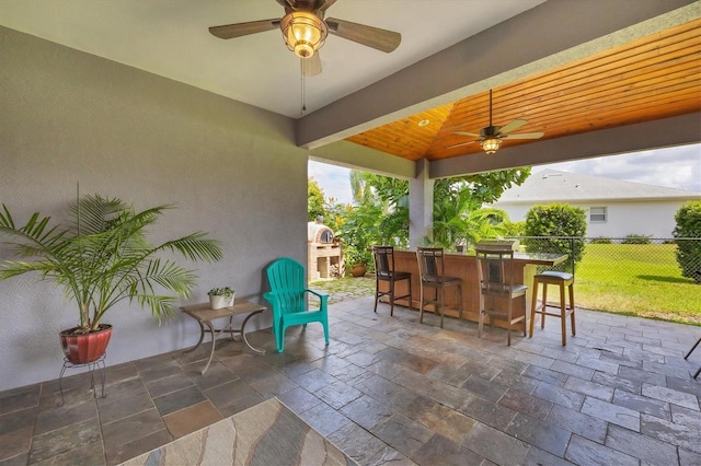 view of patio / terrace with exterior bar and ceiling fan