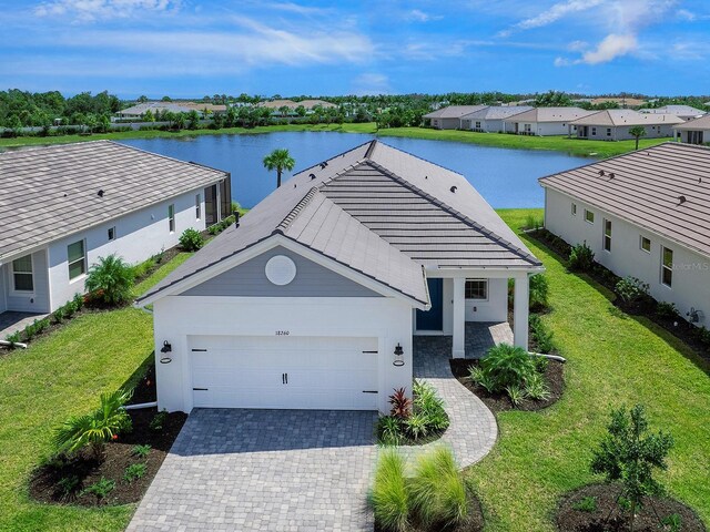 view of front of house with a front yard and a water view