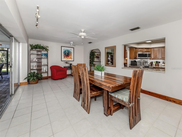 dining area with ceiling fan and light tile patterned floors