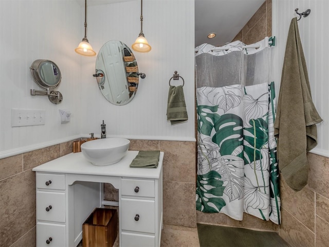 bathroom with vanity, tile walls, and a shower with shower curtain