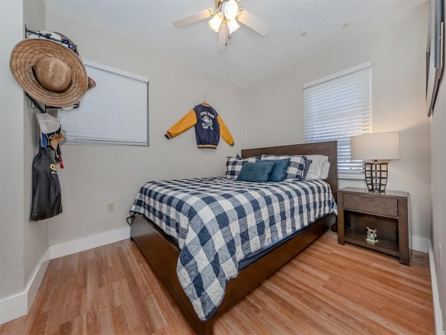 bedroom with light hardwood / wood-style flooring and ceiling fan