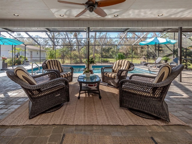 view of patio / terrace with ceiling fan and a lanai