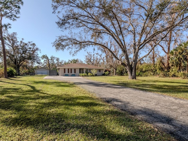 ranch-style house with a front yard and a garage