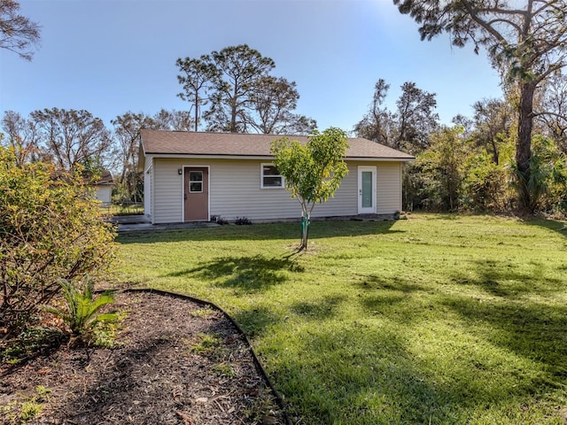 back of property featuring a lawn