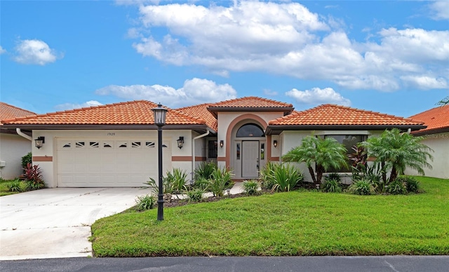 mediterranean / spanish-style house featuring a garage, a front yard, and stucco siding