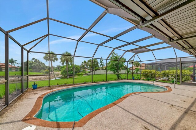 pool with glass enclosure, a lawn, and a patio