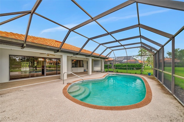 outdoor pool featuring a lanai, ceiling fan, and a patio