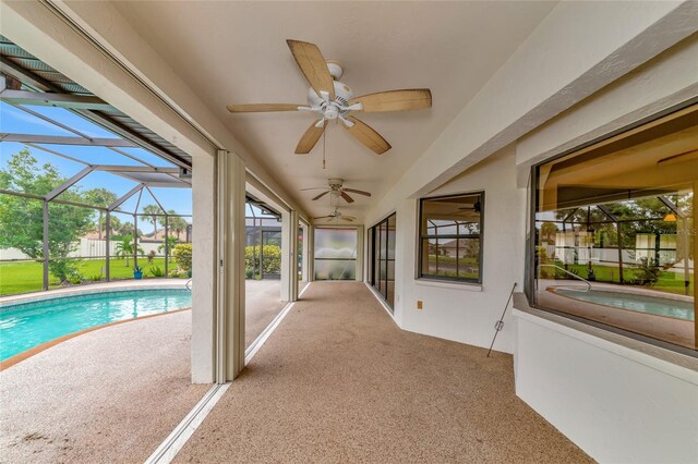 exterior space with a lanai, a patio area, and a ceiling fan