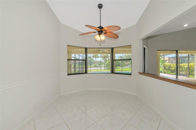 unfurnished room featuring a wealth of natural light, baseboards, and light tile patterned floors