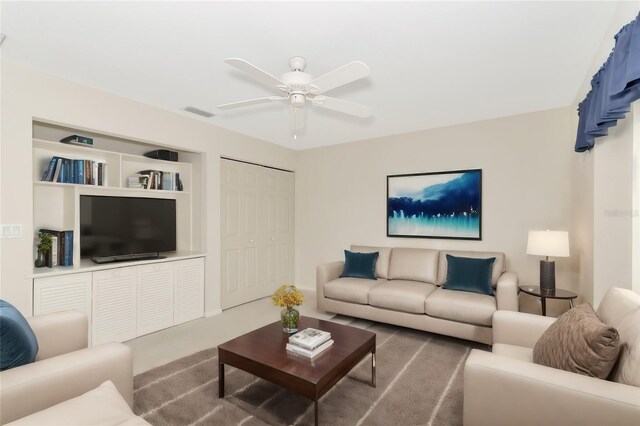 living room with ceiling fan, carpet, and visible vents