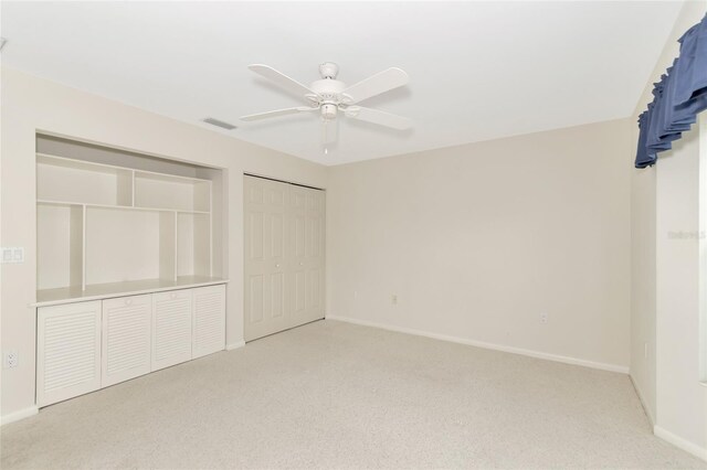 unfurnished bedroom featuring visible vents, baseboards, a ceiling fan, light colored carpet, and a closet