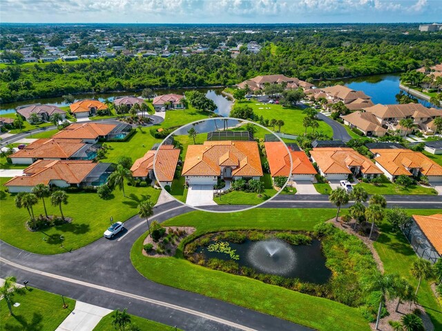 birds eye view of property with a water view and a residential view