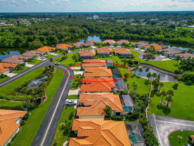 drone / aerial view featuring a water view and a residential view