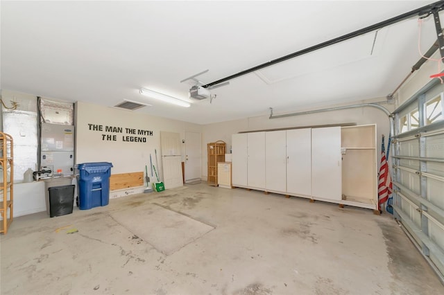 garage with a garage door opener and heating unit