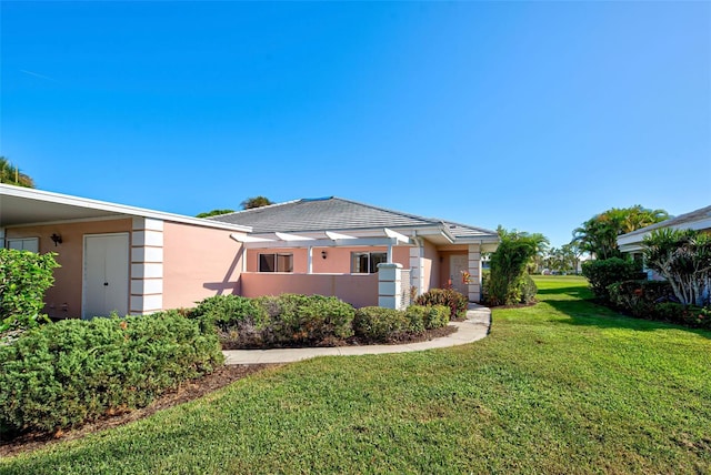 rear view of property with a yard