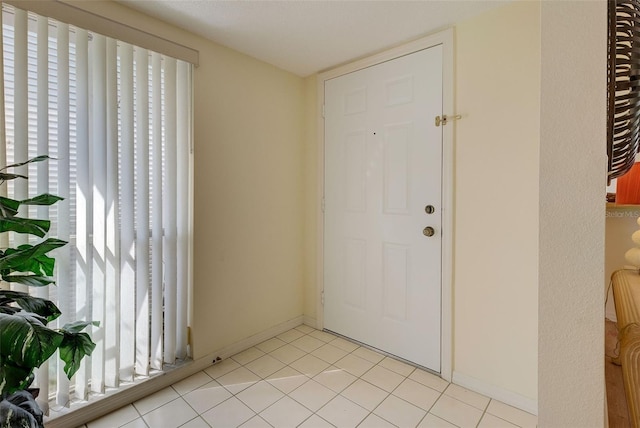 entrance foyer featuring plenty of natural light and light tile patterned floors