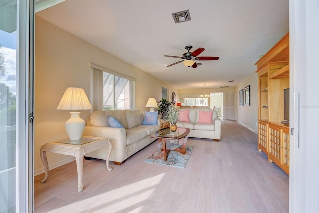 living room with ceiling fan and hardwood / wood-style flooring