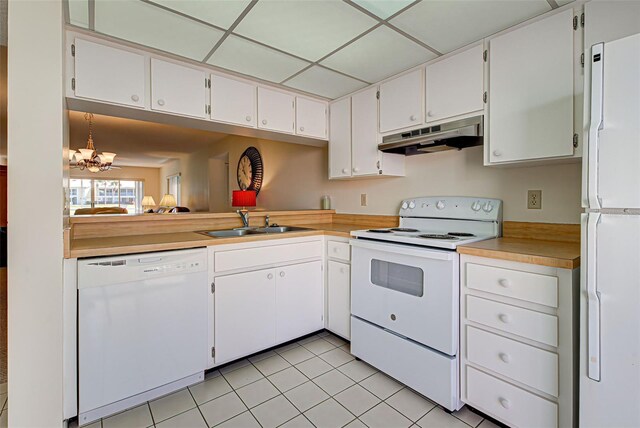 kitchen featuring sink, white cabinets, an inviting chandelier, white appliances, and light tile patterned floors