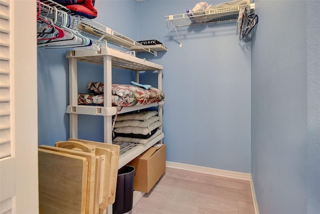 walk in closet featuring light hardwood / wood-style flooring