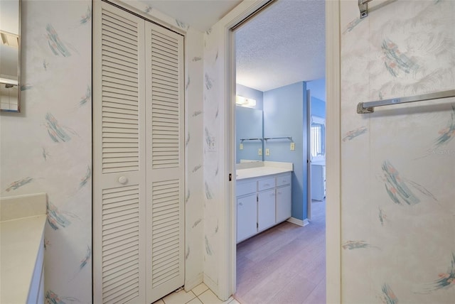 bathroom featuring vanity, a textured ceiling, and hardwood / wood-style flooring